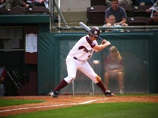 batter swinging the bat at baseball